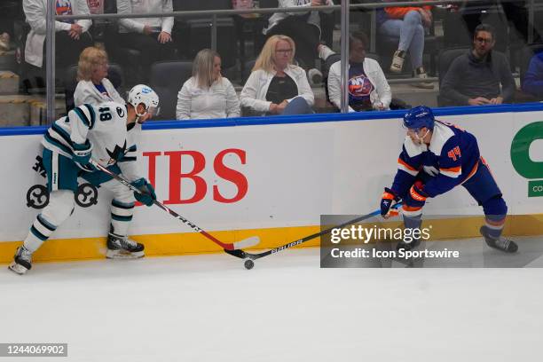 San Jose Sharks Center Tomas Hertl and New York Islanders Center Jean-Gabriel Pageau battle for the puck during the first period of the National...