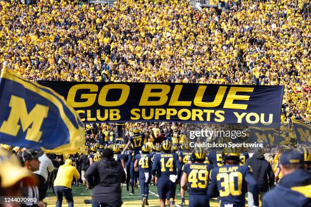 Michigan Wolverines players run onto the field prior to a college football game against the Penn State Nittany Lions on October 15, 2022 at Michigan...