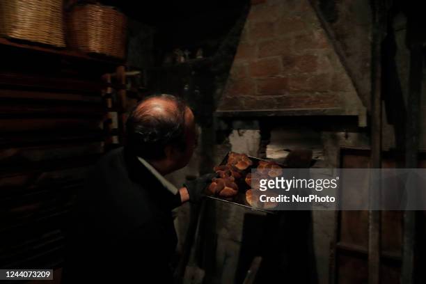 Baker pulls Pan de Muerto from a stone oven for sale in San Antonio Xochimilco, Mexico City, on the eve of Mexico's Day of the Dead on 1 and 2...
