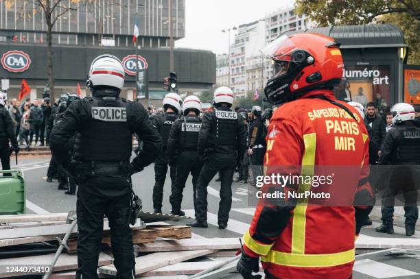 Biker firefighter from the MIR brigade accompanies BRAV-M riot police who deployed after black bloc activists attempted to build a barricade during a...