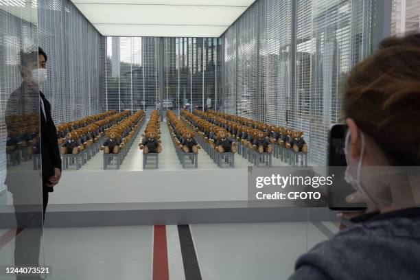 Little bears" dressed in suits sit neatly in a hut outside a Rui Ou department store in Shanghai, China, on Oct 19, 2022. It's a limited-time...