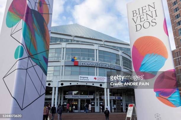 Visitors walk at the entrance of the 23rd Frankfurt Book Fair at the Messe fairground in Frankfurt am Main, western Germany, on October 19, 2022. -...
