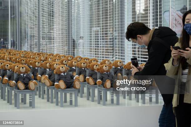 Little bears" dressed in suits sit neatly in a hut outside a Rui Ou department store in Shanghai, China, on Oct 19, 2022. It's a limited-time...