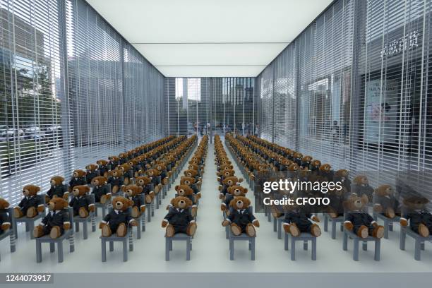 Little bears" dressed in suits sit neatly in a hut outside a Rui Ou department store in Shanghai, China, on Oct 19, 2022. It's a limited-time...