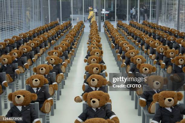 Little bears" dressed in suits sit neatly in a hut outside a Rui Ou department store in Shanghai, China, on Oct 19, 2022. It's a limited-time...