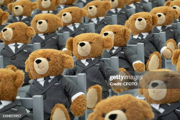 Little bears" dressed in suits sit neatly in a hut outside a Rui Ou department store in Shanghai, China, on Oct 19, 2022. It's a limited-time...