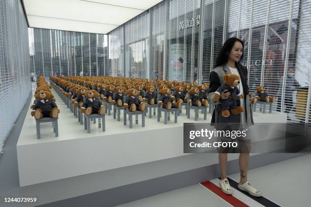 Little bears" dressed in suits sit neatly in a hut outside a Rui Ou department store in Shanghai, China, on Oct 19, 2022. It's a limited-time...