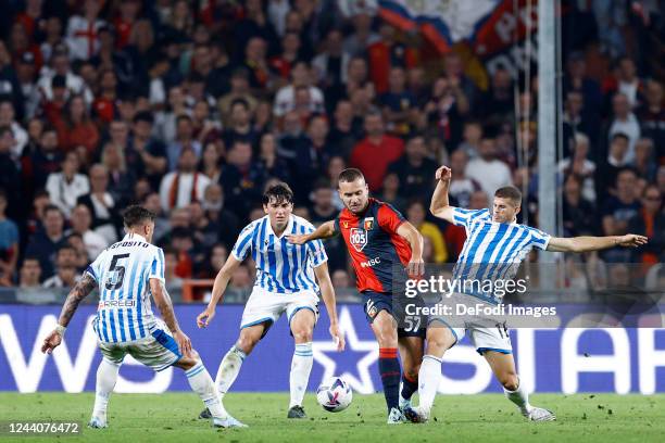 George Alexadru Puscas of Genoa CFC and Luca Valzania of SPAL battle for the ball during the Coppa Italia match between Genoa CFC and Spal at Stadio...