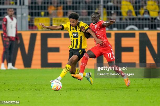 Karim Adeyemi of Borussia Dortmund and Sadio Mane of Bayern Muenchen battle for the ball during the Bundesliga match between Borussia Dortmund and FC...