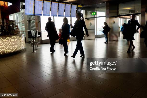 Passengers are seen walking with their luggage or waiting for boarding on the aircraft inside the terminal, the arrival and departure hall, the gates...