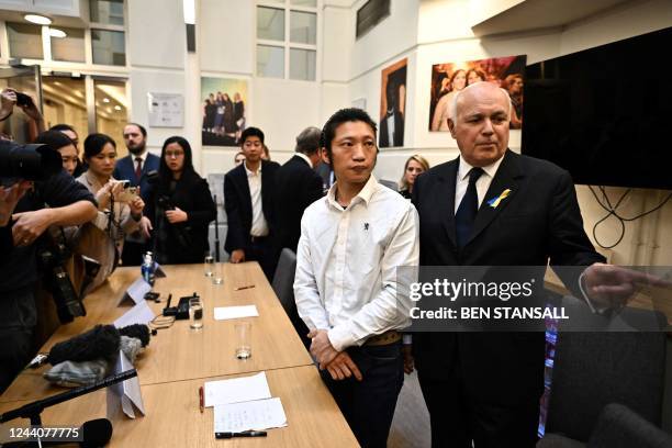 For the Conservative party Iain Duncan Smith speaks with Hong Kong pro-democracy protester Bob Chan at the ens of his press conference, in London, on...