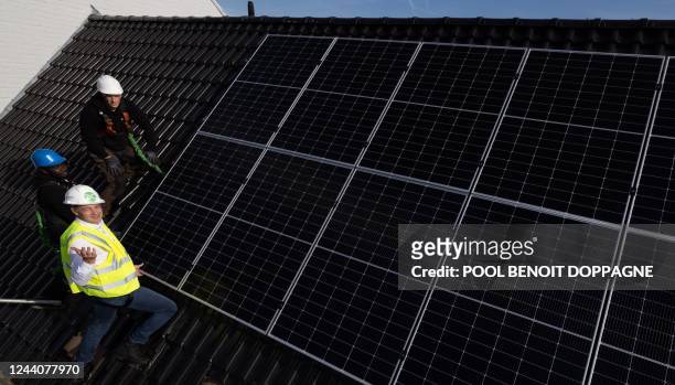 Prime Minister Alexander De Croo assists with the installation of solar panels of the EnergyHome formula by EnergyVision, Wednesday 19 October 2022...