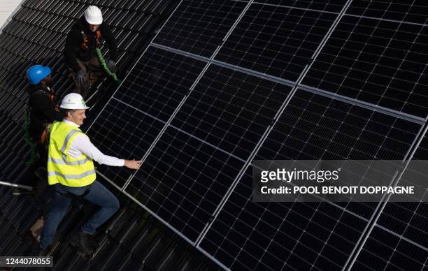 Prime Minister Alexander De Croo assists with the installation of solar panels of the EnergyHome formula by EnergyVision, Wednesday 19 October 2022...