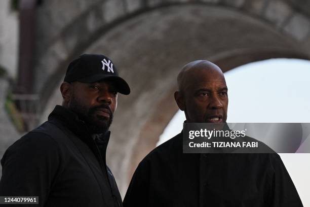 Director Antoine Fuqua and US actor Denzel Washington pose during a photocall on the set of the film "Equalizer 3", on October 19, 2022 currently...