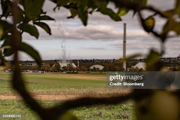 Vapor rises from the hybrid cooling tower, center left, at the Neckarwestheim Nuclear Power Station, operated by EnBW Energie Baden-Wuerttemberg AG,...