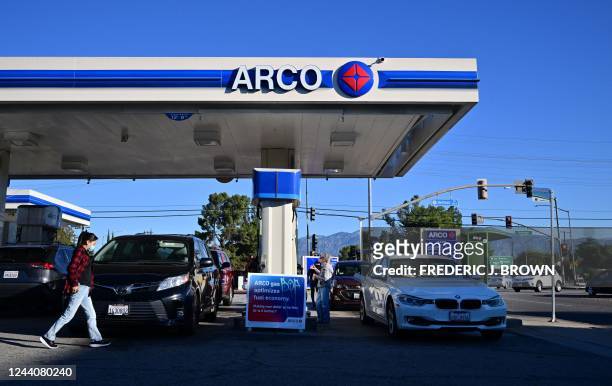 People get gas for their vehicles at a petrol station in Alhambra, California, on October 19, 2022. - US President Joe Biden will announce the...