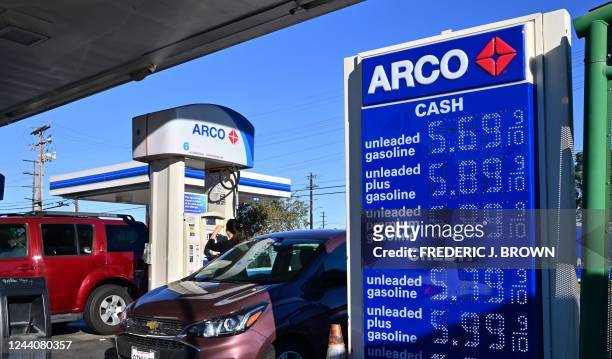 People get gas for their vehicles at a petrol station in Alhambra, California on October 19, 2022. - US President Joe Biden will announce the release...