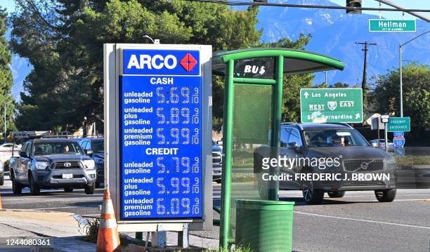 Morning commuters drive past a sign displaying gas prices at a petrol station in Alhambra, California on October 19, 2022. - US President Joe Biden...