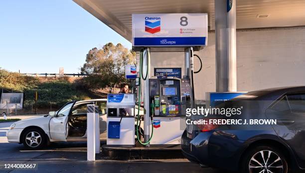 People get gas for their vehicles at a petrol station in Alhambra, California on October 19, 2022. - US President Joe Biden will announce the release...