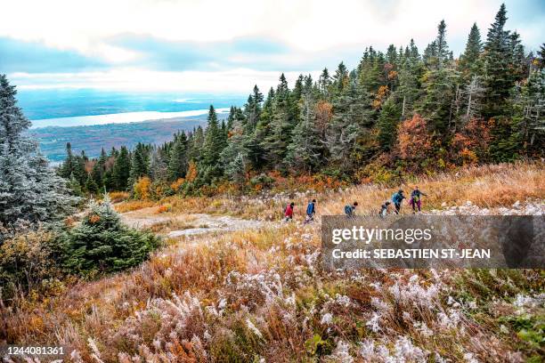 Hikers climb Mont-Orford in the Mont-Orford National Park near Orford, Quebec, Canada, on October 8, 2022.