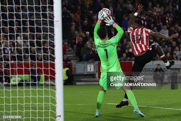Chelsea's Spanish goalkeeper Kepa Arrizabalaga stops a ball headed by Brentford's English striker Ivan Toney during the English Premier League...