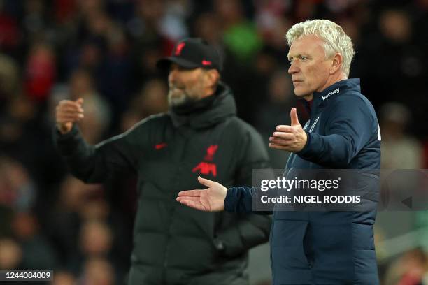 West Ham United's Scottish manager David Moyes and Liverpool's German manager Jurgen Klopp gesture on the touchline during the English Premier League...