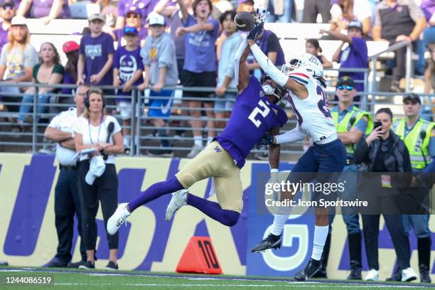 Washington JaLynn Polk and Arizona CB) Treydan Stokes battle for the ball during a college football game between the Washington Huskies and the...