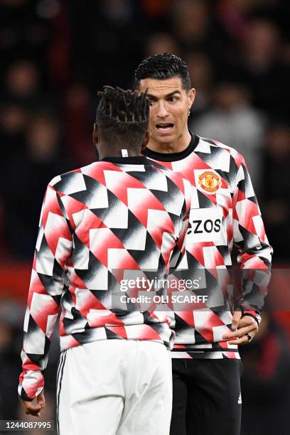 Manchester United's Portuguese striker Cristiano Ronaldo speaks to Manchester United's Brazilian midfielder Fred during the warm up prior to the...