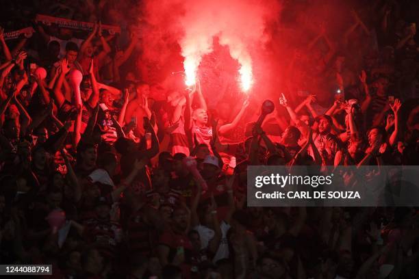 Fan of Flamengo lights flares before the start of the Brazil Cup final second leg football match between Flamengo and Corinthians at the Maracana...