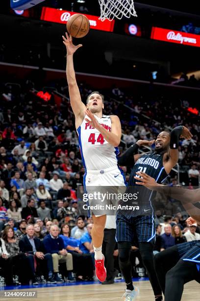 Bojan Bogdanovic of the Detroit Pistons shoots the ball against Terrence Ross of the Orlando Magic during the fourth quarter at Little Caesars Arena...