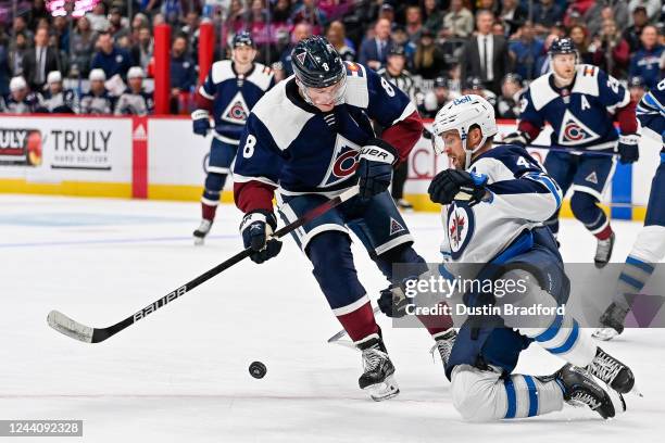 Cale Makar of the Colorado Avalanche has a shot blocked by Josh Morrissey of the Winnipeg Jets in the second period at Ball Arena on October 19, 2022...