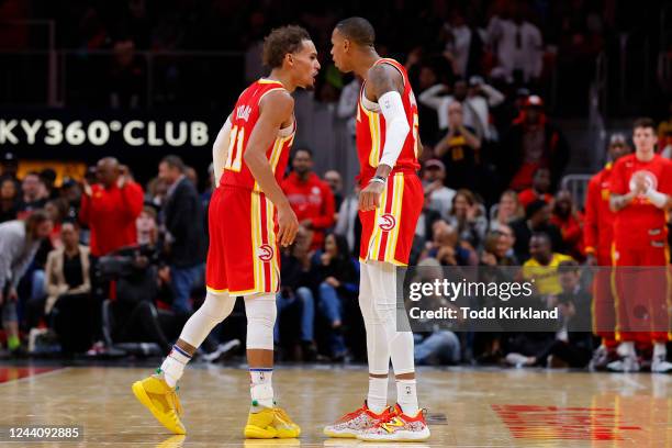 Trae Young and Dejounte Murray of the Atlanta Hawks react during the second half against the Houston Rockets at State Farm Arena on October 19, 2022...