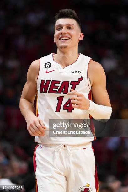 Tyler Herro of the Miami Heat smiles as he runs up court during the first half against the Chicago Bulls at FTX Arena on October 19, 2022 in Miami,...