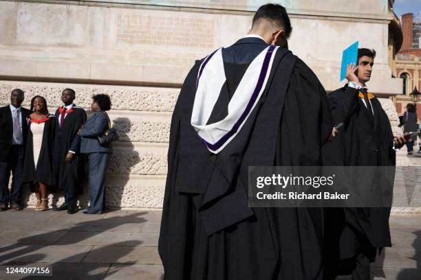 Talented young graduates from Imperial College London celebrate their education success with friends and families after their graduation ceremony at...