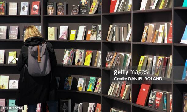 Visitor looks at books displayed at the stand of Spain, this year's Guest of Honor, at the Frankfurt Book Fair at the Messe fairground in Frankfurt...