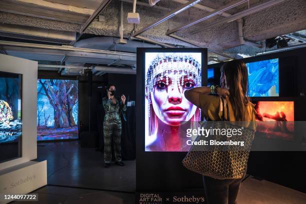 Visitors look at artworks at the Digital Art Fair in Hong Kong, China, on Thursday, Oct. 20, 2022. The show runs through to Nov. 6. Photographer: Lam...