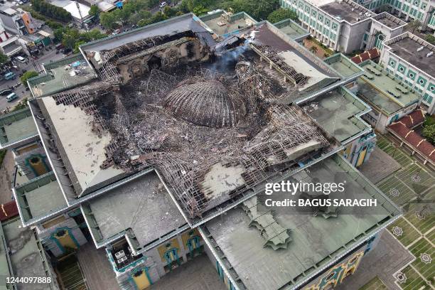 This aerial picture taken on October 20, 2022 shows the smouldering remains of the collapsed dome of the Islamic Centre mosque in Jakarta, which...