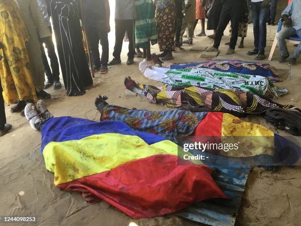 Bodies covered by Chadian flag lies on the ground during a protest in NDjamena on October 20, 2022. - Clashes erupted in the Chadian capital...
