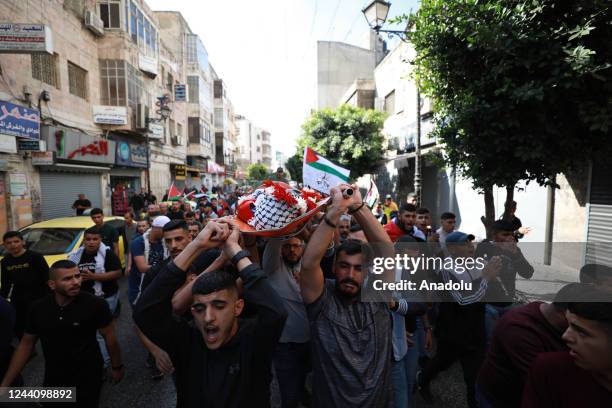 People carry the dead body of 16-year-old Mohammed Fadi Nouri during his funeral in Ramallah, West Bank on October 20, 2022. Mohammad Fadi Nouri died...