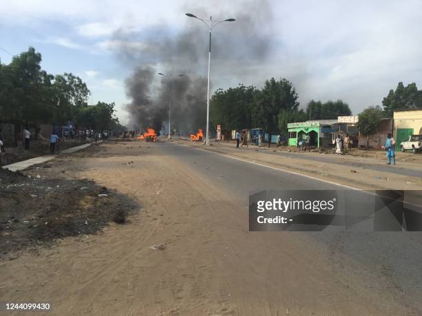 This photograph taken on October 20 shows burning barricades in a deserted street in NDjamena during demonstrations. - Clashes erupted in the Chadian...