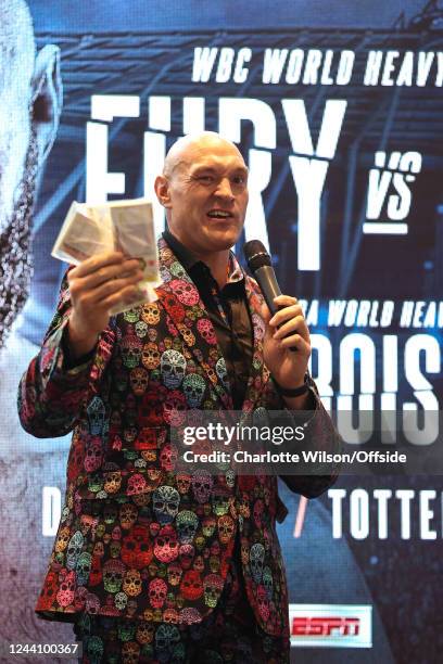 Tyson Fury with £10,000 won in a bet after Anthony Joshua refused to fight him during the Tyson Fury Press Conference at Tottenham Hotspur Stadium on...