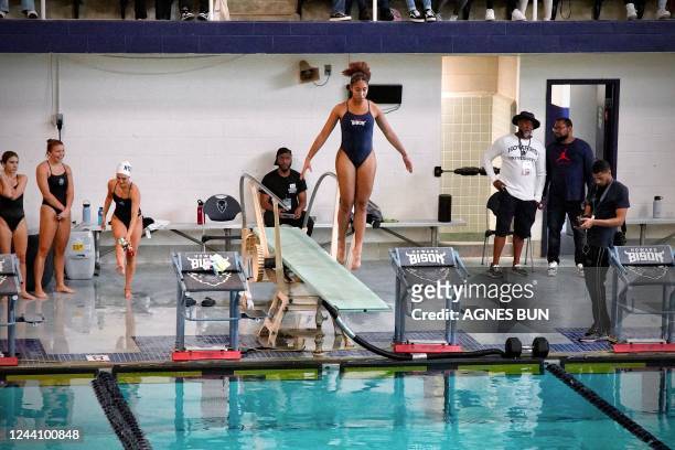 Member of the swim team of Howard University jumps from a diving board during a competition against the swim team of Georgetown University at the...