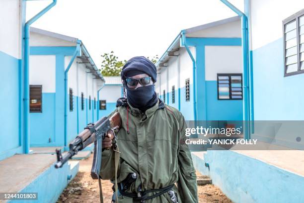 Togolese policeman, disguised as a terrorist, brandishes his weapon on October 20, 2022 during an anti-terrorism exercise at the Peacekeeping...
