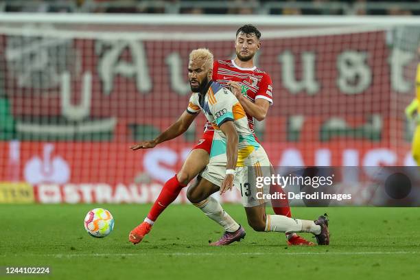Eric Maxim Choupo-Moting of Bayern Muenchen and Maximilian Bauer of FC Augsburg battle for the ball during the DFB Cup second round match between FC...