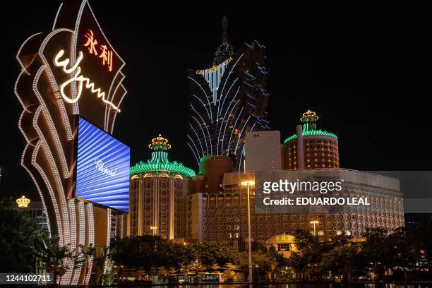 This photograph taken on October 20, 2022 shows the signage of Wynn Casino resort with the Grand Lisboa and Casino Lisboa in the backdrop in Macau.