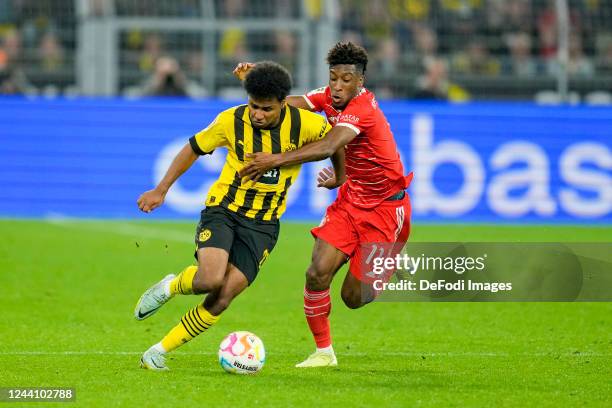 Donyell Malen of Borussia Dortmund and Kingsley Coman of Bayern Muenchen battle for the ball during the Bundesliga match between Borussia Dortmund...