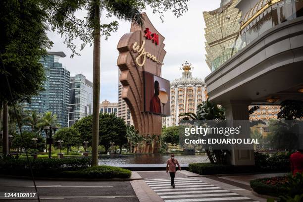 This photograph taken on October 20, 2022 shows a pedestrian walking to the Wynn Casino in Macau.