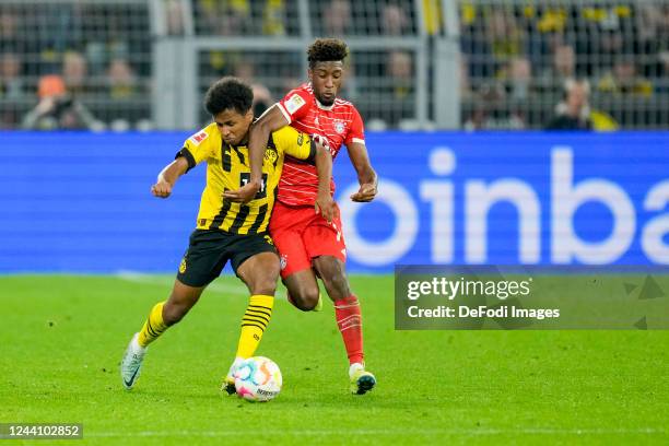 Donyell Malen of Borussia Dortmund and Kingsley Coman of Bayern Muenchen battle for the ball during the Bundesliga match between Borussia Dortmund...