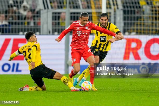 Jude Bellingham of Borussia Dortmund and Leroy Sane of Bayern Muenchen battle for the ball during the Bundesliga match between Borussia Dortmund and...