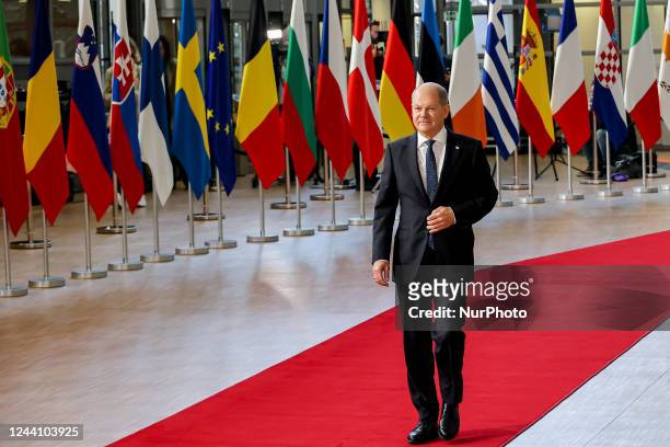 Olaf Scholz Federal Chancellor of Germany arriving at the EU summit, walking next to the European flags, flag of Europe and talks to the media while...